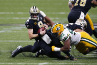 New Orleans Saints quarterback Drew Brees (9) is sacked by Green Bay Packers defensive end Kingsley Keke (96) in the first half of an NFL football game in New Orleans, Sunday, Sept. 27, 2020. (AP Photo/Brett Duke)