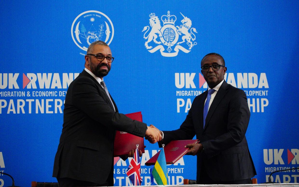 James Cleverly and Dr Vincent Biruta, the Rwandan foreign minister, shake hands after the treaty signing