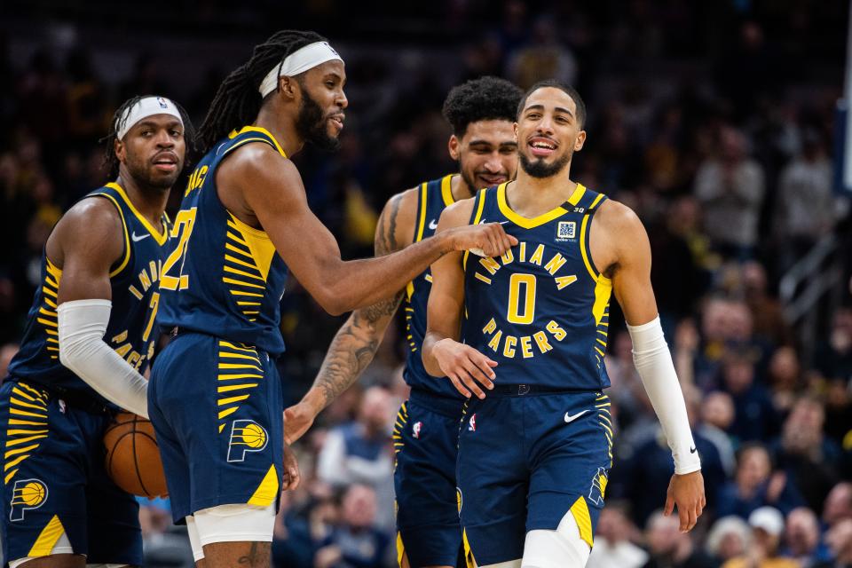 Jan 3, 2024; Indianapolis, Indiana, USA; Indiana Pacers guard Tyrese Haliburton (0) celebrates with teammates a made basket and foul in the second half against the Milwaukee Bucks at Gainbridge Fieldhouse. Mandatory Credit: Trevor Ruszkowski-USA TODAY Sports