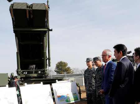 Australian Prime Minister Malcolm Turnbull (2nd R) and Japanese Prime Minister Shinzo Abe listen an explanation in front of a PAC-3 missile interceptor at Narashino exercise field in Funabashi, east of Tokyo, Japan January 18, 2018. REUTERS/Kim Kyung-Hoon