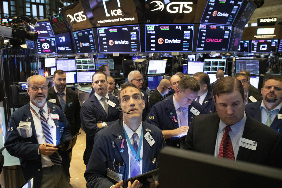 FILE - In this Sept. 18, 2019, file photo traders at the New York Stock Exchange follow stock prices just before the Federal Reserve made its interest rate announcement. Investors hit the brakes on a hard-charging market over the last two quarters as the U.S.-China trade war created an uncertain economic path forward. (AP Photo/Mark Lennihan, File)