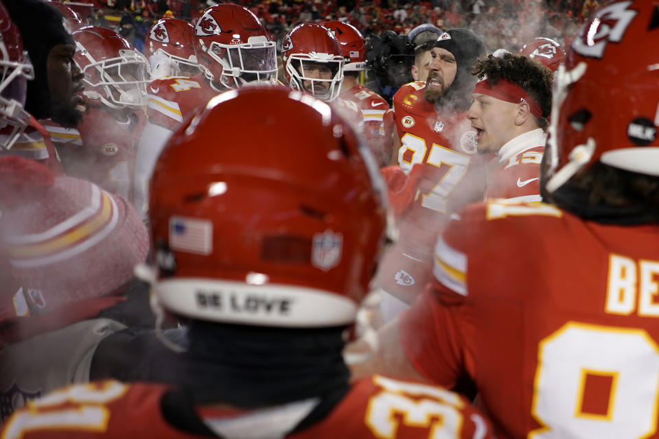 Kansas City Chiefs quarterback Patrick Mahomes, second from right, and tight end Travis Kelce, third from right, huddle with teammates before an NFL wild-card playoff football game against the Miami Dolphins Saturday, Jan. 13, 2024, in Kansas City, Mo. (AP Photo/Charlie Riedel)