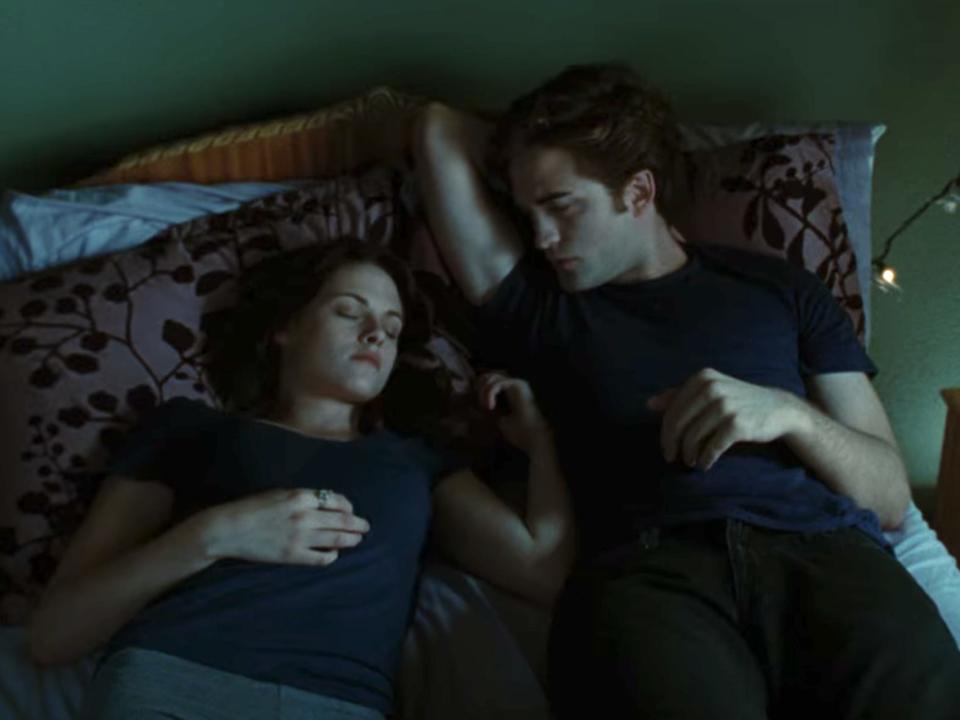 Edward (Robert Pattinson) watches Bella (Kristen Stewart) sleep in a scene from "Twilight."