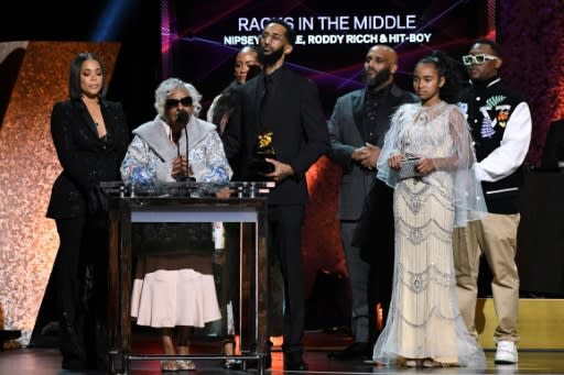 Samiel Asghedom (C), brother of late US rapper Nipsey Hussle, his grandmother (2nd L), and other relatives accept the award for Best Rap Performance for "Racks in the Middle"