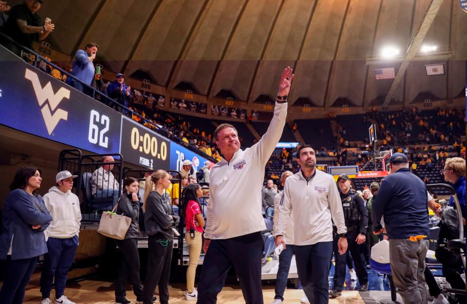 Kansas head coach Bill Self waves to fans Saturday after defeating West Virginia at WVU Coliseum in Morgantown.