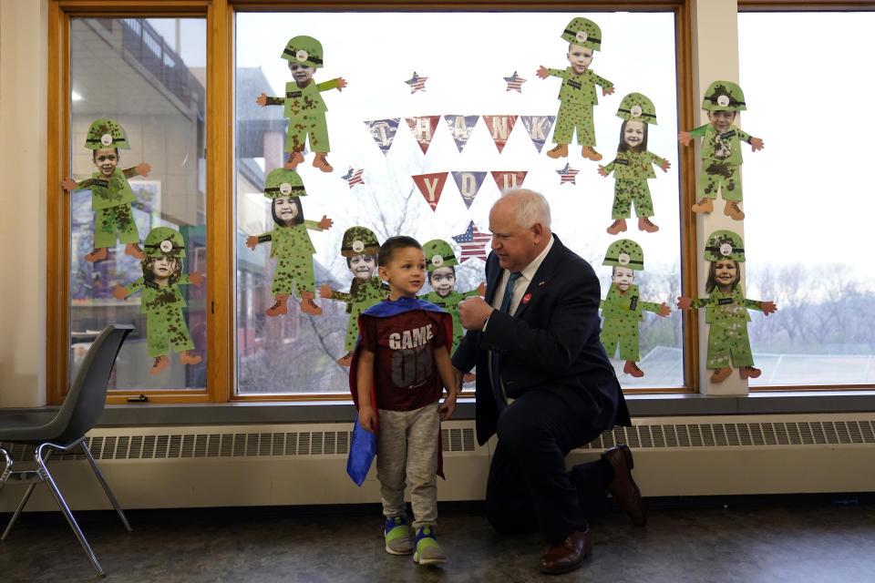 Minnesota Gov. Tim Walz, right, fist-bumps with Binny, 4, after voting Tuesday, Nov. 8, 2022, in St. Paul. (AP Photo/Abbie Parr)