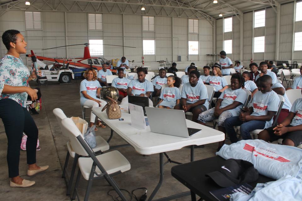 Candace Harney, left, owner of Royal Queendom International, speaks about the different opportunities in aviation during 100 Black Men of Greater Florida GNV Inc. 4th Annual Aviation Academy on June 25 at the University Air Center at 4701 NE 40th Terrace.