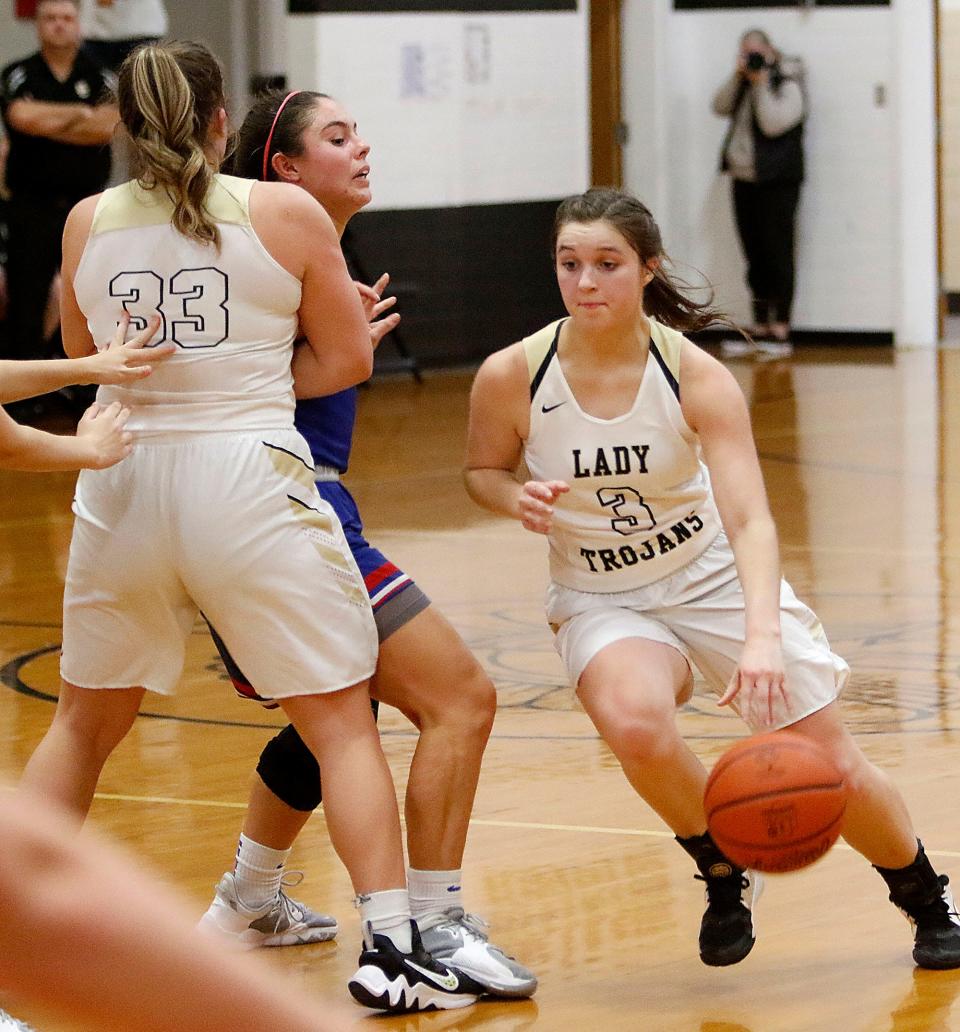 South Central High School's Kendyl Beverly (3) drives past Mapleton High School's Sara Hickey (3) as Claire Osborn (33) sets the pick during high school girls basketball action Friday, Dec. 10, 2021 at South Central High School. TOM E. PUSKAR/TIMES-GAZETTE.COM