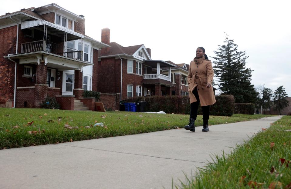 Sauda Ahmad-Green from S&S Development Group stands on Friday, December 8, 2023 in front of the home she grew up in on Virginia Park Street not far from the Merrill Place townhomes that she and her group developed.