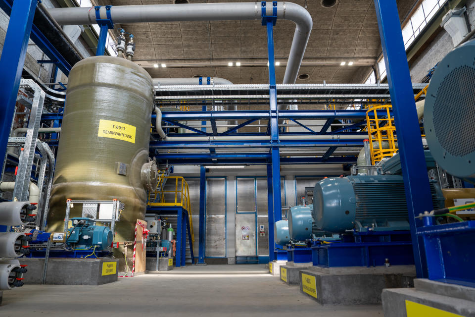 Interior shot of water circulation pumps to the right, and pure feed-water tank to the left.