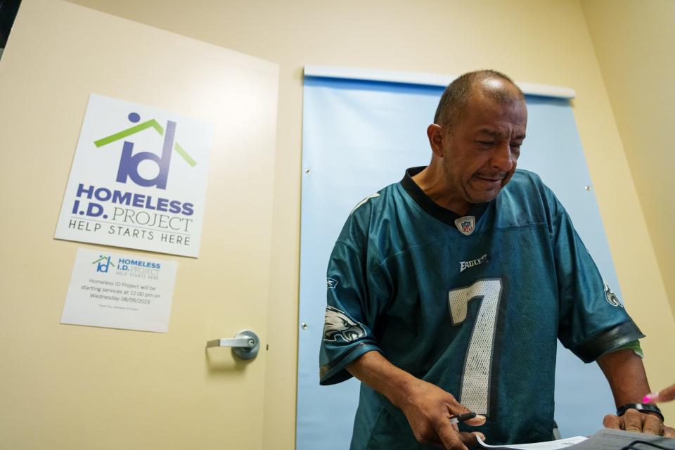 Mike Jimenez receives a temporary ID from the Motor Vehicle Department office in the Brian Garcia Welcome Center at the Human Services Campus on Aug. 7, 2023, in Phoenix. After visiting the MVD office, people experiencing homelessness can have their permanent IDs delivered to the campus post office just across the hall from the MVD office in the Welcome Center.