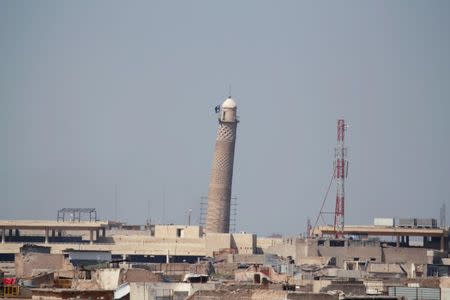 A flag of Islamic State militants is seen on top of Mosul's Al-Hadba minaret at the Grand Mosque, where Islamic State leader Abu Bakr al-Baghdadi declared his caliphate back in 2014, during clashes between Iraqi forces and Islamic State militants in Mosul, Iraq, March 24, 2017. REUTERS/Khalid al Mousily