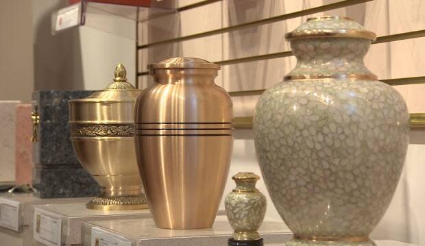 A display of urns for holding cremated remains.  According to a 2019 B.C. Vital Statistics report, cremations are much more common than burials in Smithers, B.C., but the community doesn't allow cremations within town limits.  (Sherry Vivian/CBC - image credit)