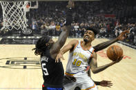 Golden State Warriors guard Jacob Evans, right, shoots as Los Angeles Clippers forward Montrezl Harrell defends during the first half of an NBA basketball game Friday, Jan. 10, 2020, in Los Angeles. (AP Photo/Mark J. Terrill)