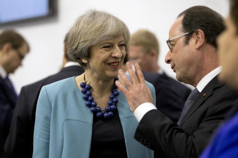 British Prime Minister Theresa May, center left, speaks with French President Francois Hollande during an EU summit round table meeting at the Grand Masters Palace in Valletta, Malta, on Friday, Feb. 3, 2017. European Union heads of state and government gathered Friday for a one day summit to discuss migration and the future of the EU. (AP Photo/Virginia Mayo)