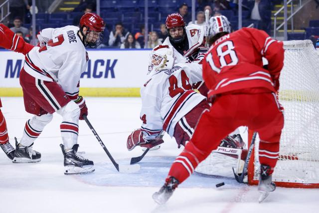 Harvard University goalie Mitchell Gibson (44) uses his leg to block a shot by Ohio State forward Michael Gildon (18) during the first period of an NCAA hockey game on Friday, March 24, 2023, in Bridgeport, Conn. (AP Photo/Greg M. Cooper)