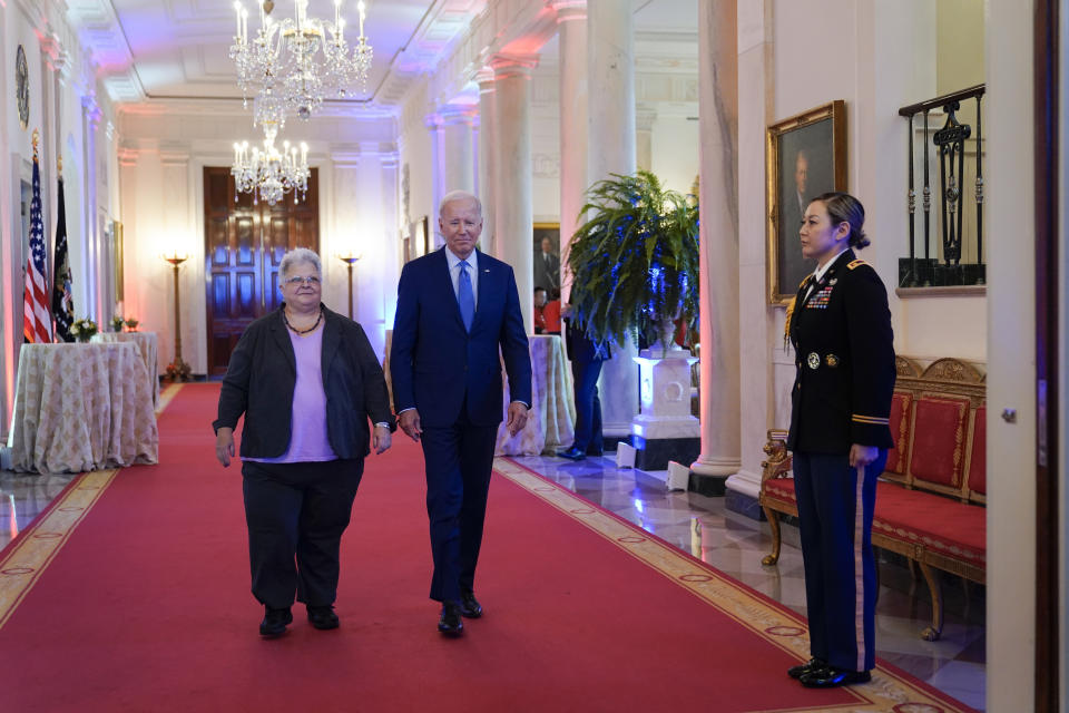 President Joe Biden arrives with Susan Bro, mother of Heather Heyer who was killed in 2017 during a white supremacist rally, during the United We Stand Summit in the East Room of the White House in Washington, Thursday, Sept. 15, 2022. The summit is aimed at combating a spate of hate-fueled violence in the U.S., as he works to deliver on his campaign pledge to "heal the soul of the nation." (AP Photo/Susan Walsh)