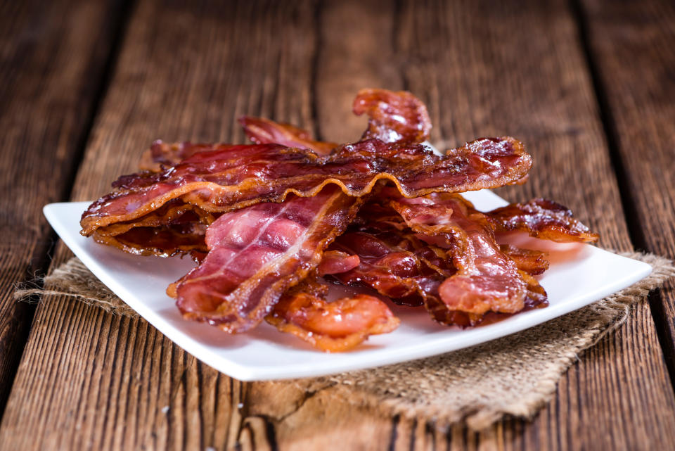 Fried Bacon (selective focus) on an old vintage wooden table