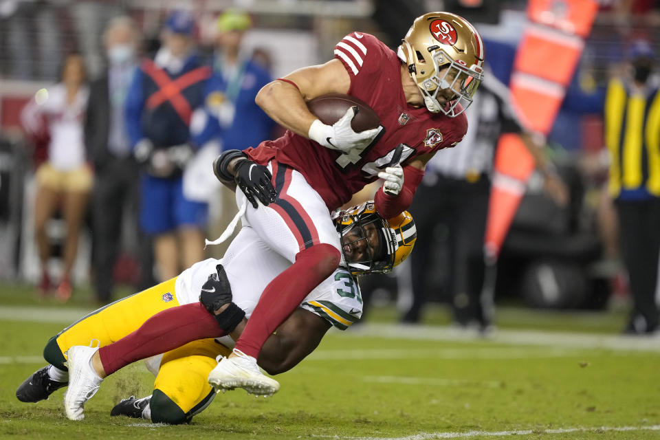 San Francisco 49ers fullback Kyle Juszczyk, top, runs toward the end zone to score against Green Bay Packers strong safety Adrian Amos during the second half of an NFL football game in Santa Clara, Calif., Sunday, Sept. 26, 2021. (AP Photo/Tony Avelar)