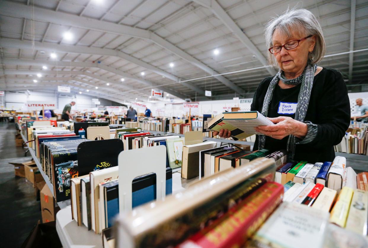 Friends of the Library volunteer Paula Dirkers unpacks and sorts boxes of books for the Spring 2023 Book Sale at the Ozark Empire Fairgrounds E-Plex on Monday, April 24, 2023. 