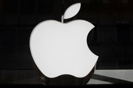 FILE PHOTO: The logo of Apple is seen at a store in Zurich, Switzerland January 3, 2019. REUTERS/Arnd Wiegmann