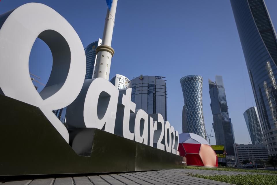 FILE - Branding is displayed near the Doha Exhibition and Convention Center in Doha, Qatar, Thursday, March 31, 2022. Qatar is a devoutly apolitical place, with speech and assembly heavily restricted and a large population of foreign workers who could lose their livelihoods if they cause a stir. But that could change next month, when an estimated 1.2 million soccer fans descend on the tiny Gulf Arab nation for the World Cup. (AP Photo/Darko Bandic, File)