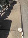 Baseballs fouled off by players are seen stopped at the bottom row of the Oakland Coliseum after rolling down through empty stands during the baseball game between the Los Angeles Angels and the Oakland Athletics on Monday, July 27, 2020, in Oakland, Calif. (AP Photo/Ben Margot)