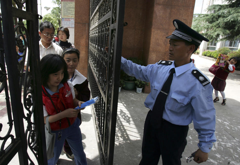 Pupils enter a primary school in Kunming