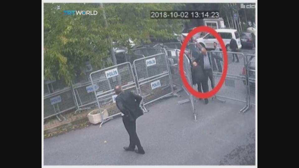 This image taken from CCTV video obtained by the Turkish broadcaster TRT World and made available on Sunday, Oct. 21, 2018, purportedly showing Saudi journalist Jamal Khashoggi, is allowed to pass barriers blocking the road leading toe the Saudi consulate in Istanbul, Tuesday, Oct. 2, 2018. Khashoggi's fiancee Hatice Cengiz, with headscarf, is partially seen to his right. (CCTV/TRT World via AP)