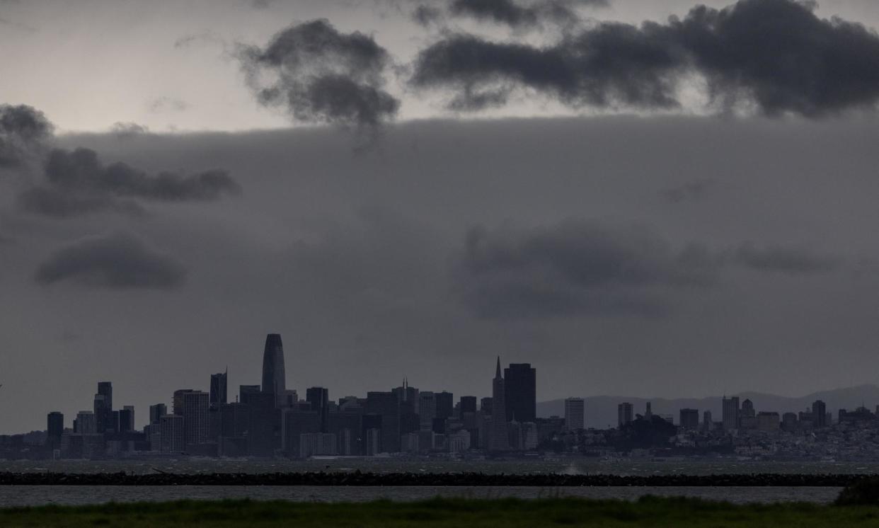 <span>The San Francisco skyline as a Pacific storm approaches, in Richmond, California, on Wednesday.</span><span>Photograph: Carlos Barría/Reuters</span>