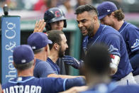 Tampa Bay Rays' Nelson Cruz is congratulated by teammates after hitting a solo home run during the third inning of the teams' baseball game against the Cleveland Indians, Friday, July 23, 2021, in Cleveland. (AP Photo/Tony Dejak)