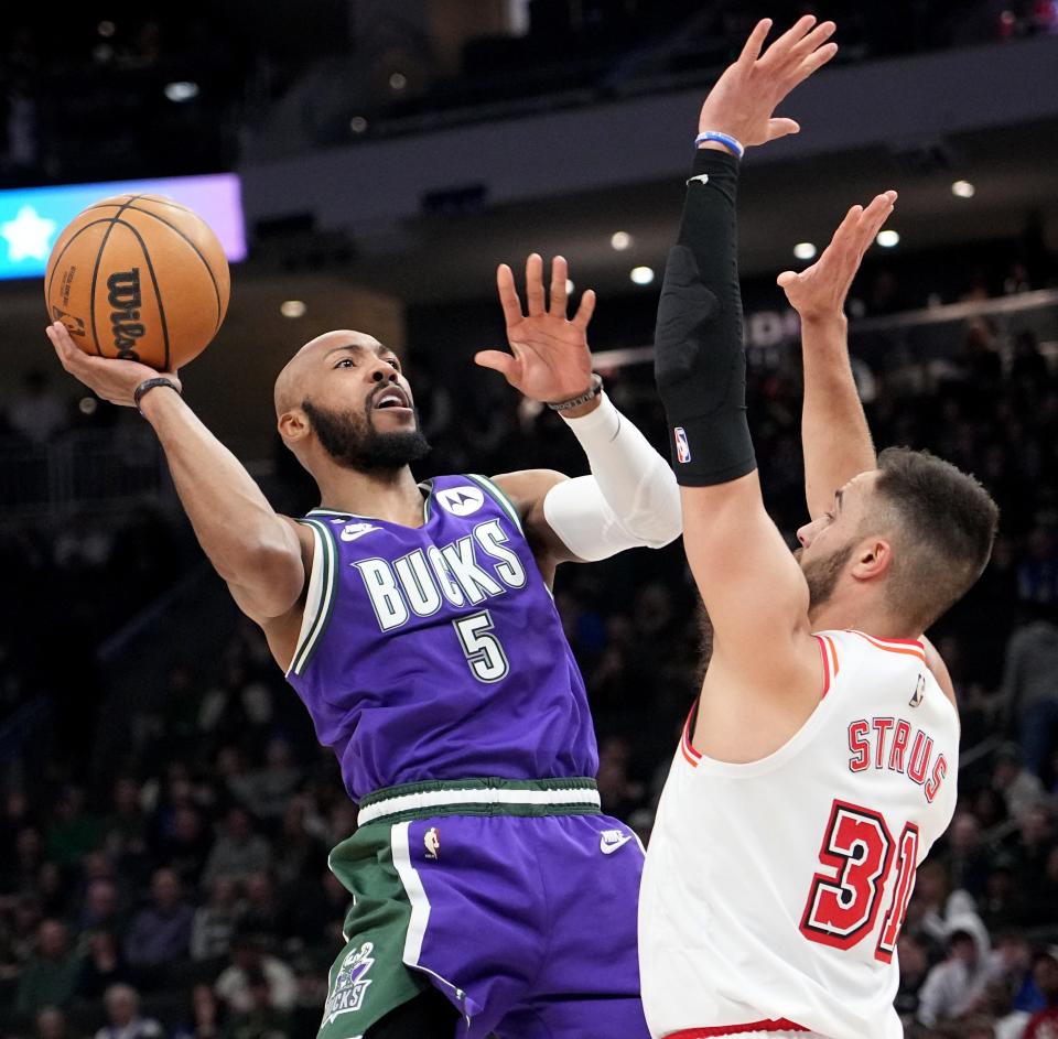 Milwaukee Bucks guard Jevon Carter (5) scores on Miami Heat guard Max Strus (31) during the second half of their game Friday, February 24, 2023 at Fiserv Forum in Milwaukee Wis. The Milwaukee Bucks beat the Miami Heat 128-99.