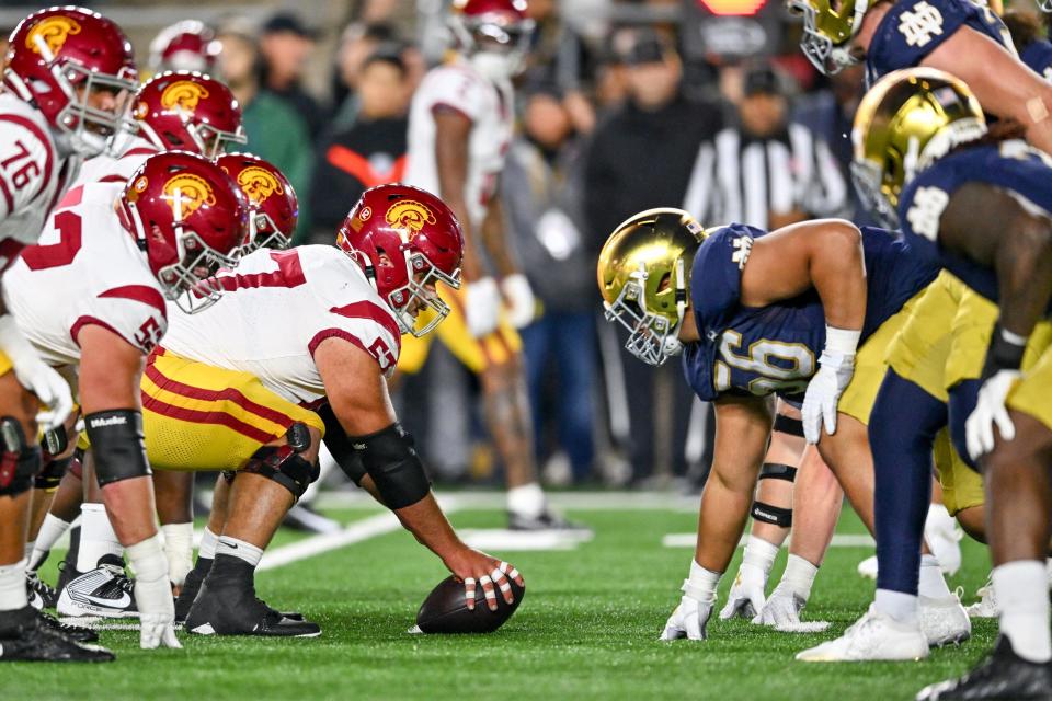 Oct 14, 2023; South Bend, Indiana, USA; USC Trojans center Justin Dedich (57) prepares to snap as Notre Dame Fighting Irish defensive lineman Howard Cross III (56) defends in the second quarter at Notre Dame Stadium. Mandatory Credit: Matt Cashore-USA TODAY Sports