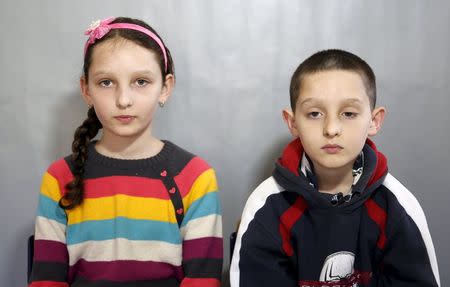 Twins Mubina (L) and Mufid Veladzic pose for a portrait in a primary school in Buzim April 10, 2015. REUTERS/Dado Ruvic