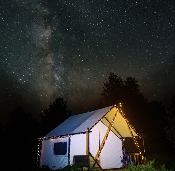 Stars are shown above a tent at the Beaver Island Retreat.