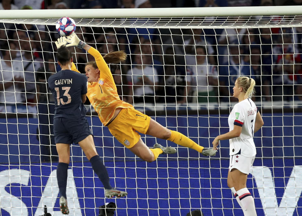 United States goalkeeper Alyssa Naeher (1) deflects the ball away from France's Valerie Gauvin during the Women's World Cup quarterfinal soccer match between France and the United States at the Parc des Princes, in Paris, Friday, June 28, 2019. (AP Photo/Francisco Seco)