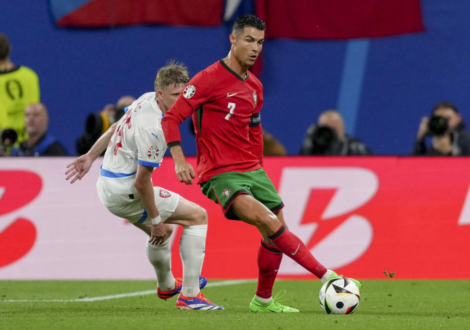 Portugal's Cristiano Ronaldo, right, and Czech Republic's David Jurasek challenge for the ball during a Group F match between Portugal and Czech Republic at the Euro 2024 soccer tournament in Leipzig, Germany, Tuesday, June 18, 2024. (AP Photo/Sunday Alamba)