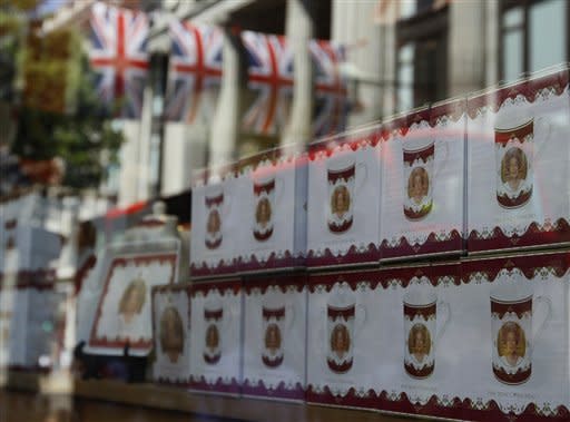 Reflections of the British Union flag are seen in a shop window displaying Diamond Jubilee souvenirs, in Oxford Street, London, Friday, May 25, 2012. The capital is preparing to celebrate the Diamond Jubilee, marking the Queen's 60 year reign. (AP Photo/Kirsty Wigglesworth)