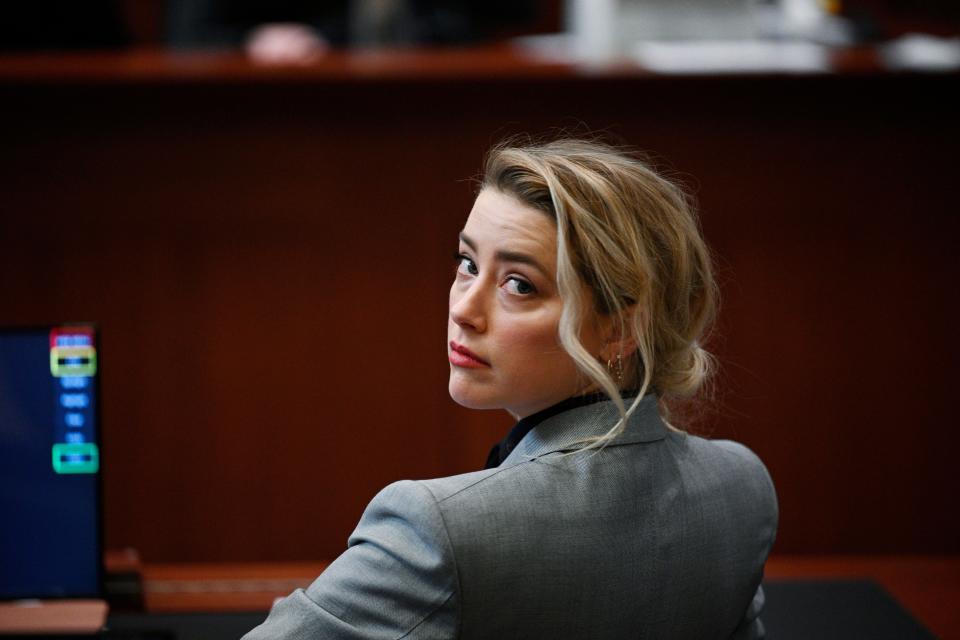 Actress Amber Heard is seen inside the courtroom at the Fairfax County Circuit Court April 12, 2022, in Fairfax, Va. A jury in Virginia is scheduled to hear opening statements in a defamation lawsuit filed by Johnny Depp against his ex-wife, Amber Heard. Depp says Heard libeled him when she wrote an op-ed piece in The Washington Post in 2018 referring to herself as a “public figure representing domestic abuse.” Depp is never mentioned by name, but he says the article implicates him nonetheless because it refers to past accusations Heard made when she sought a restraining order against him. A c