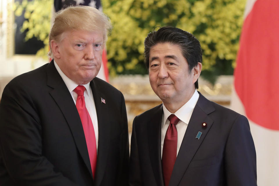FILE - In this May 27, 2019, file photo, U.S. President Donald Trump, left, and Japanese Prime Minister Shinzo Abe pose for a photo prior to their meeting at Akasaka Palace, Japanese state guest house, in Tokyo. Japan’s defense spending is expected to set a new record next year as the country strengthens its military alliance with the U.S. and buys expensive American weapons amid threats from China and North Korea. Under pressure from Trump, Japan has been buying costly military equipment as a way of reducing the U.S. trade deficit while bolstering defense cooperation. (AP Photo/Eugene Hoshiko, Pool, File)