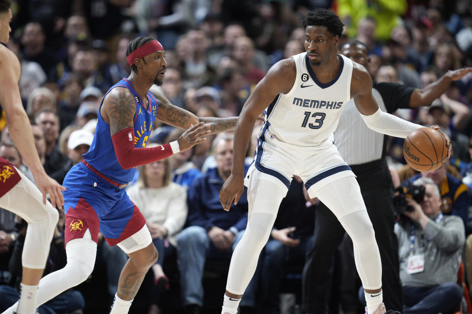 Memphis Grizzlies forward Jaren Jackson Jr., right, looks to pass the ball as Denver Nuggets guard Kentavious Caldwell-Pope defends in the first half of an NBA basketball game Friday, March 3, 2023, in Denver. (AP Photo/David Zalubowski)