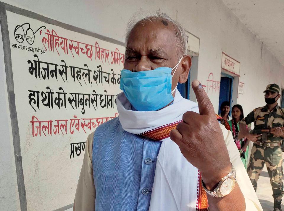 HAM(S) President Jitan Ram Manjhi shows his finger marked with indelible ink at a polling station after casting his vote for the first phase Bihar Assembly polls, at Atri in Gaya district, Wednesday, 28 October.