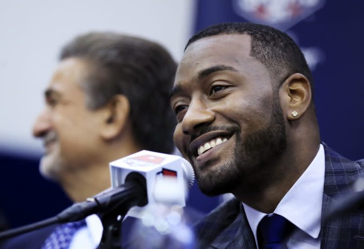 John Wall smiles at his news conference to announce his contract extension, with Wizards owner Ted Leonsis in the background. (Getty Images)