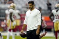 San Francisco 49ers quarterback Jimmy Garoppolo watches warms ups prior to an NFL football game against the Arizona Cardinals, Sunday, Oct. 10, 2021, in Glendale, Ariz. (AP Photo/Darryl Webb)