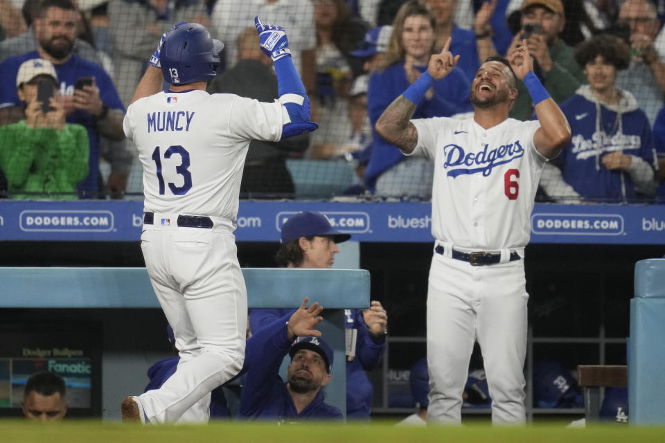 Los Angeles Dodgers' Max Muncy (13) celebrates with David Peralta (6) after he hit a home run during the third inning of a baseball game in Los Angeles, Monday, May 15, 2023. Will Smith also scored. (AP Photo/Ashley Landis)