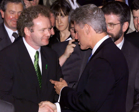 FILE PHOTO - U.S. President Bill Clinton (C) shakes the hand of Sinn Fein chief negotiator Martin McGuinness as Sinn Fein President Gerry Adams (R) watches, following Clinton's speech at the Waterfront Hall in Belfast September 3, 1995. REUTERS/File Photo