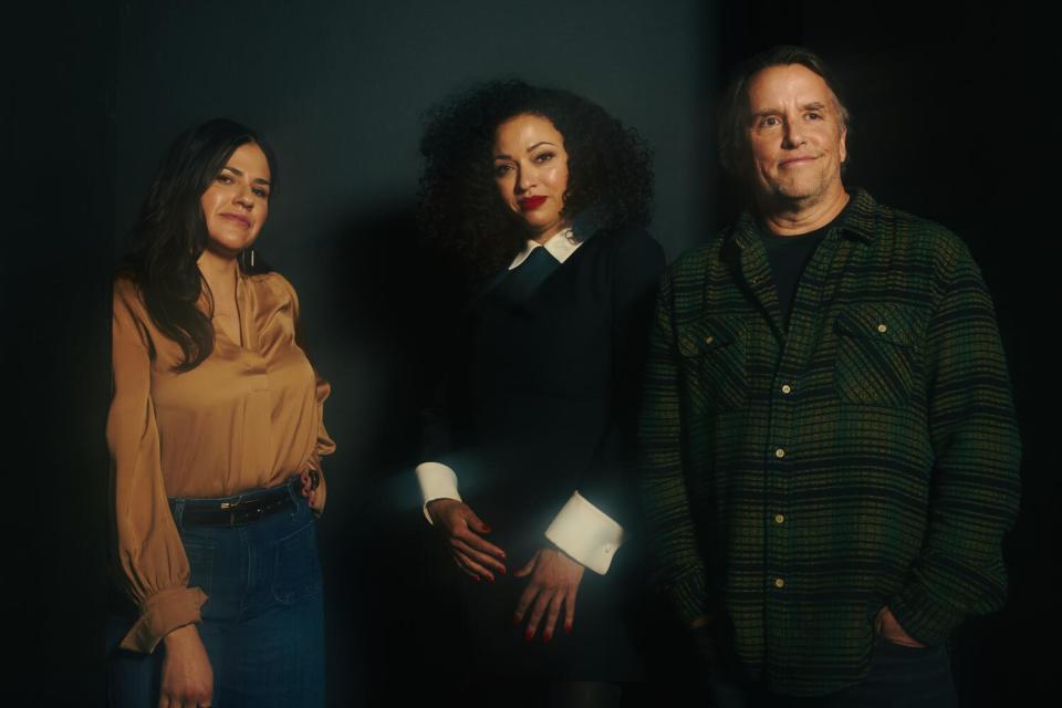 Three people pose for a portrait.