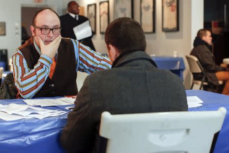 A man listens to a job interviewer during a screening session for seasonal jobs at Coney Island in the Brooklyn borough of New York March 4, 2014. REUTERS/Shannon Stapleton