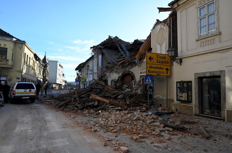 A picture shows the rubbles of damaged buildings in Petrinja, some 50kms from Zagreb, after the town was hit by an earthquake of the magnitude of 6,4 on December 29, 2020. - The tremor, one of the strongest to rock Croatia in recent years, collapsed rooftops in Petrinja, home to some 20,000 people, and left the streets strewn with bricks and other debris. Rescue workers and the army were deployed to search for trapped residents, as a girl was reported dead. (Photo by DENIS LOVROVIC / AFP) (Photo by DENIS LOVROVIC/AFP via Getty Images)