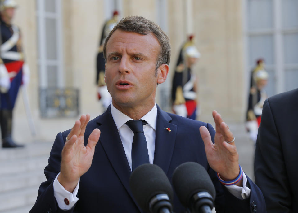 French President Emmanuel Macron gestures as he speaks to the media after a meeting United Nations and European officials with at the Elysee Palace in Paris, France, Monday, July 22, 2019. European ministers have met in Paris seeking unity on how to deal with migrants crossing the Mediterranean Sea. (AP Photo/Michel Euler)